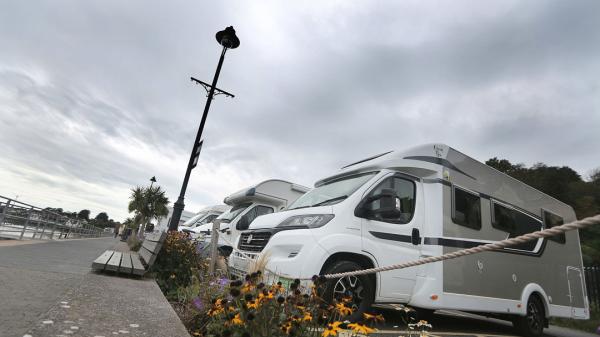 A group of motorhomes parked in a motorhome parking