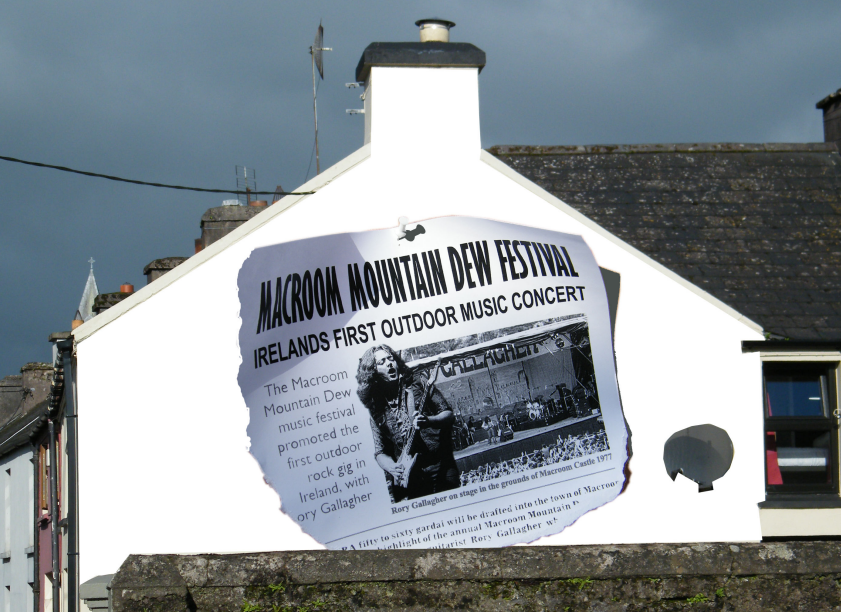 A mural on the gable end of a house depicting a newspaper article
