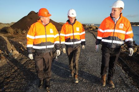 A group of men in safety vests