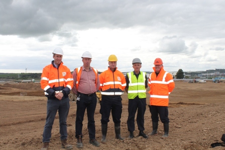 A group of men in visibilty vests