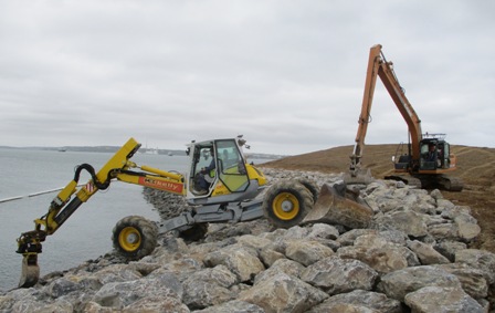 A digging machine on rocks