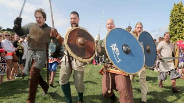 Four Reenactors charge into battle - Norman Style.