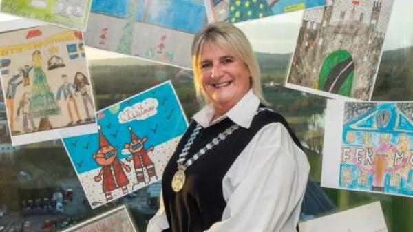 Mayor of the County of Cork, Cllr. Mary Linehan Foley displaying A Real Cork Christmas postcard entries designed by children in 4th class around Cork County.