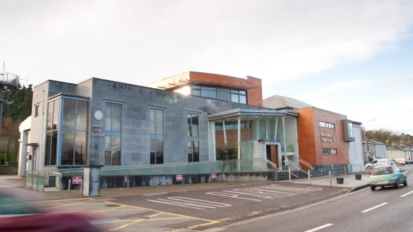 grey and re building with cars passing