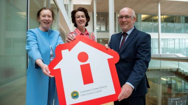 Mayor, Divisional Manager and Director of Housing holding a house shaped prop