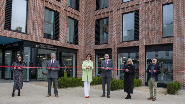 5 members of Cork County Council pictured in front of the New Bandon Library cutting a red ribbon to mark the opening 
