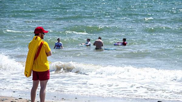 A picture containing outdoor, water, beach, shore