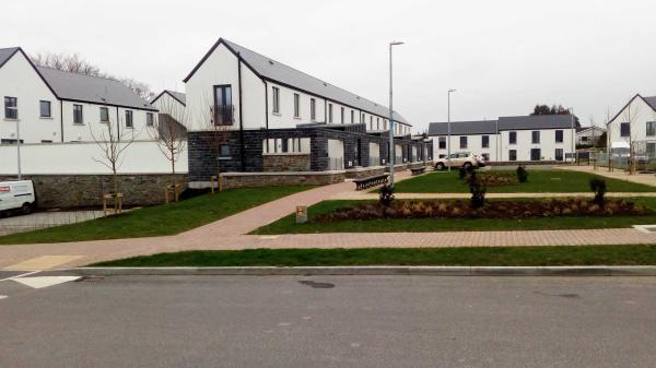 A picture containing grass, outdoor, sky, road, housing estate