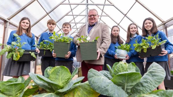 The Mayor of the county of cork with school children, holding flower boxes