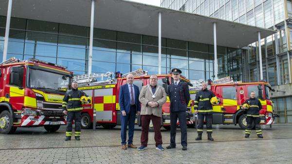 Chief Executive Tim Lucey, Mayor of the County of Cork, Cllr. Danny Collins and Chief Fire Officer Seamus Coughlan along with three members of Cork County Fire Service standing in front of three new fire engines.