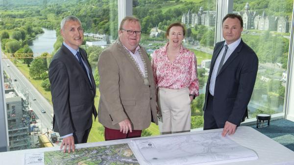Mayor Collins and 3 others reviewing maps of phase 1 of the Bantry Relief Road.
