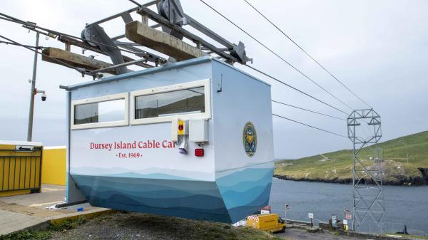 A cable Car with Island in the background