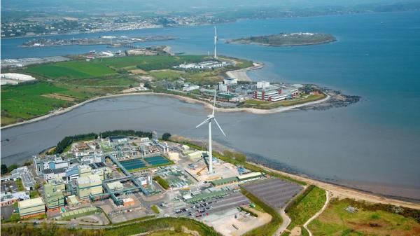 An aerial view of a factory by a harbour