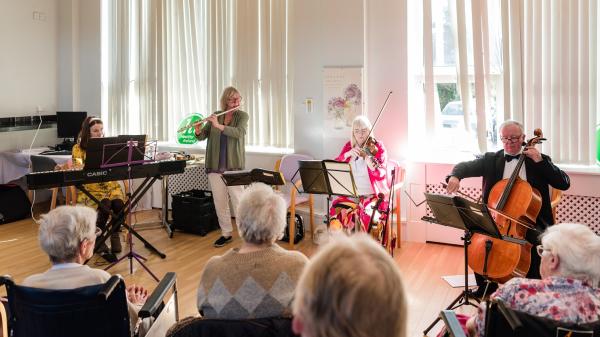 A musical quartet playing in a care home.