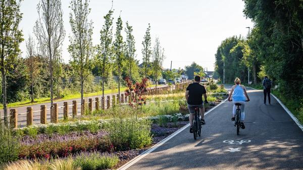 Two people cycling on a designated cycle route.