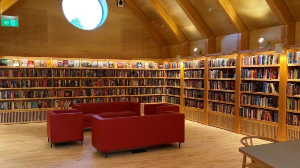 Library bookshleves with red chairs