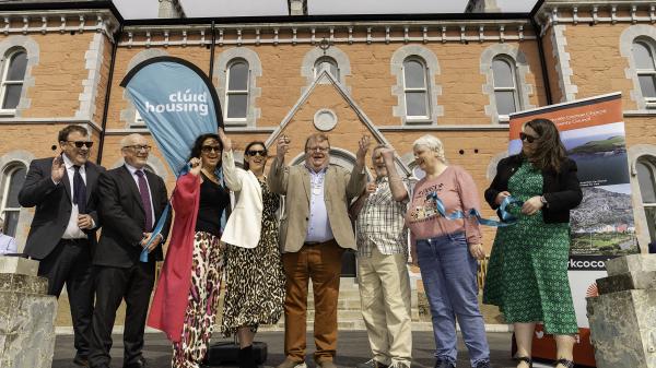 A group of people cutting a ribbon