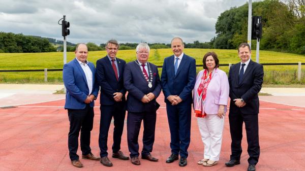 A group of people in suit near a new road