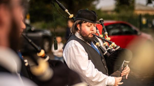 A man playing the bagpipes.