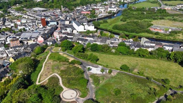 A brids eye view of a town with houses and green areas.