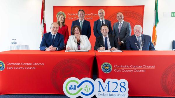 Pictured at the M28 Cork to Ringaskiddy Motorway contract signing seated left to right are: Taoiseach Micheál Martin; Moira Murrell, Chief Executive of Cork County Council; Alasdair Henderson, Executive Director, BAM Ireland; and Cllr Martin Coughlan, Deputy Mayor of the County of Cork. Standing are Geraldine Fitzpatrick, Transport Infrastructure Ireland; Minister for Transport, Darragh O'Brien; Padraig Barrett, Director of Service, Cork County Council and Minister of State, Jerry Buttimer.