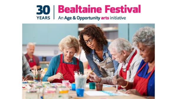 Attendees celebrating at Bealtaine Festival, surrounded by colorful banners and engaging in various cultural activities.