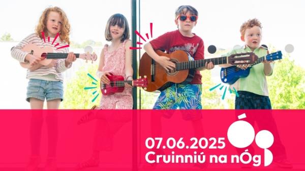  A group of four children holding guitars poses happily in front of a bright window, ready to play music together. With Text Cruinniu na NoG