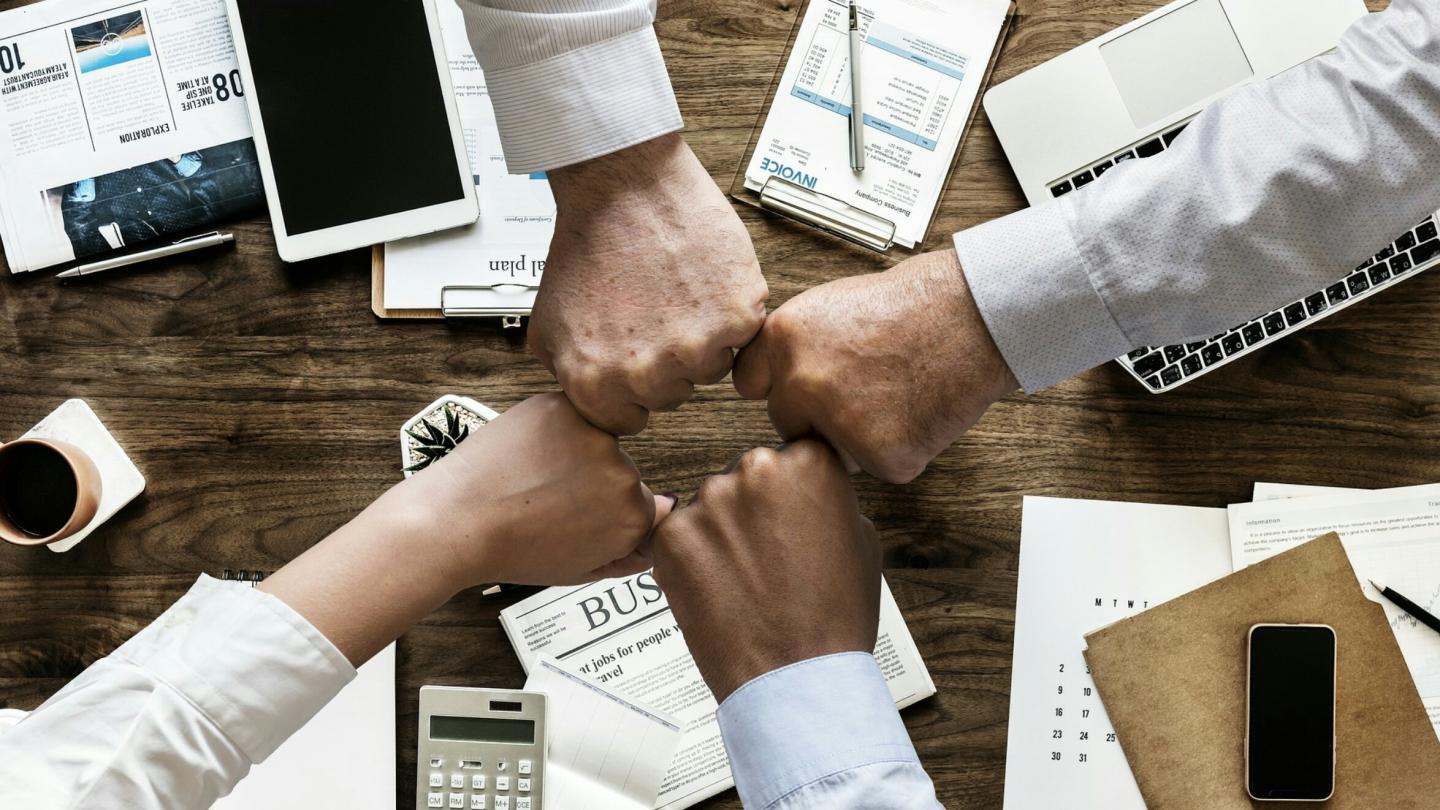 Hand fist bumping of a office table