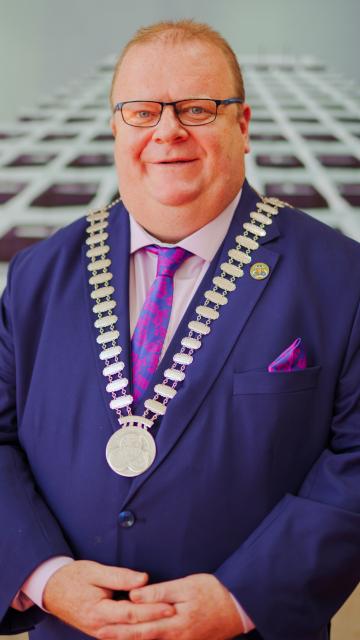 A portrait of a man with Mayoral Chains