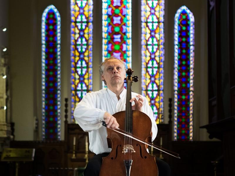 A map playing a violin in a church