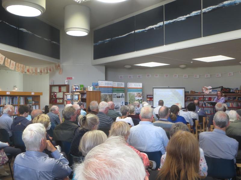 A crowd of people sitting down