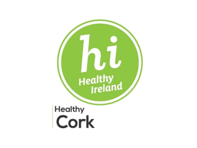 Logo of Healthy Ireland with text "hi Healthy Ireland" in a green circle, and "Healthy Cork" below it.