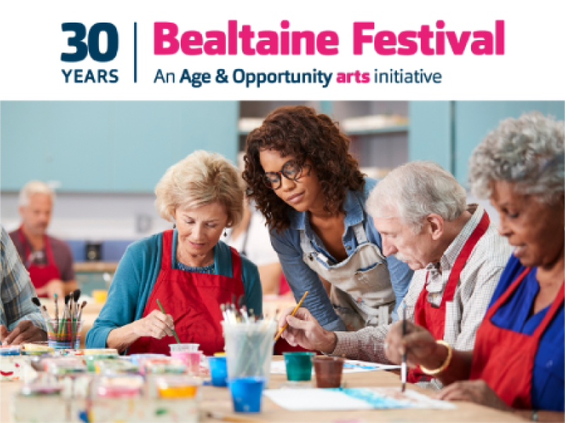 Attendees celebrating at Bealtaine Festival, surrounded by colorful banners and engaging in various cultural activities.