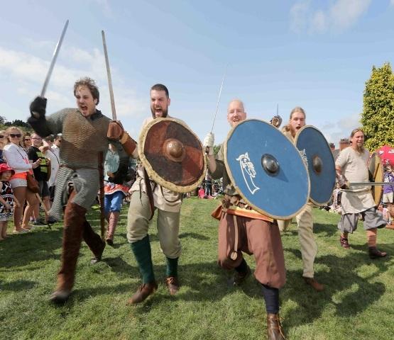 Four Reenactors charge into battle - Norman Style.