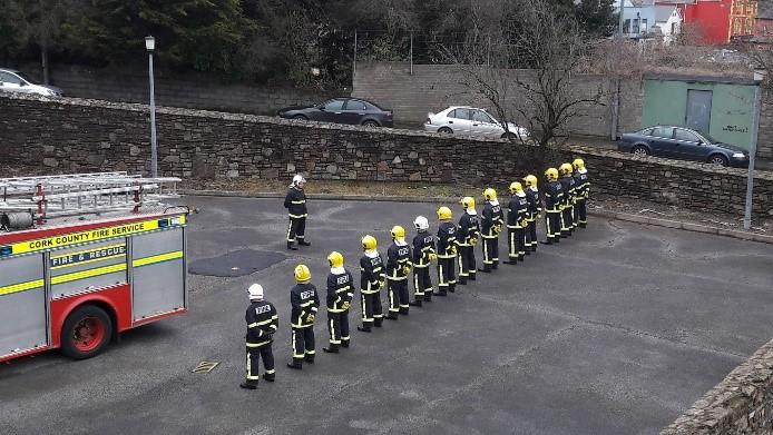 Fire Fighters Standing to Attention in a Yard