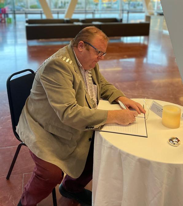 Man signing book in foyer