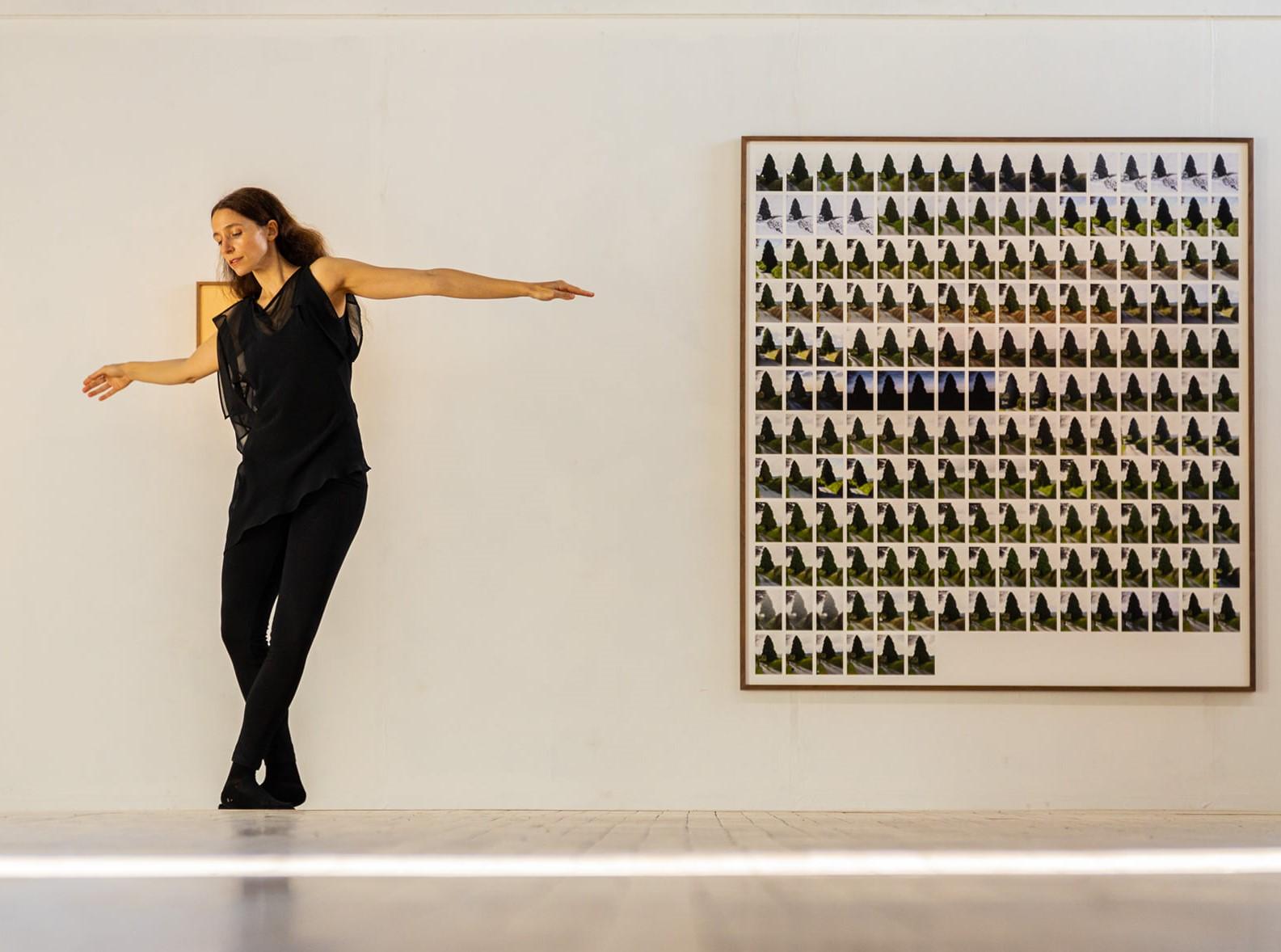 A woman dancing in front of a painting