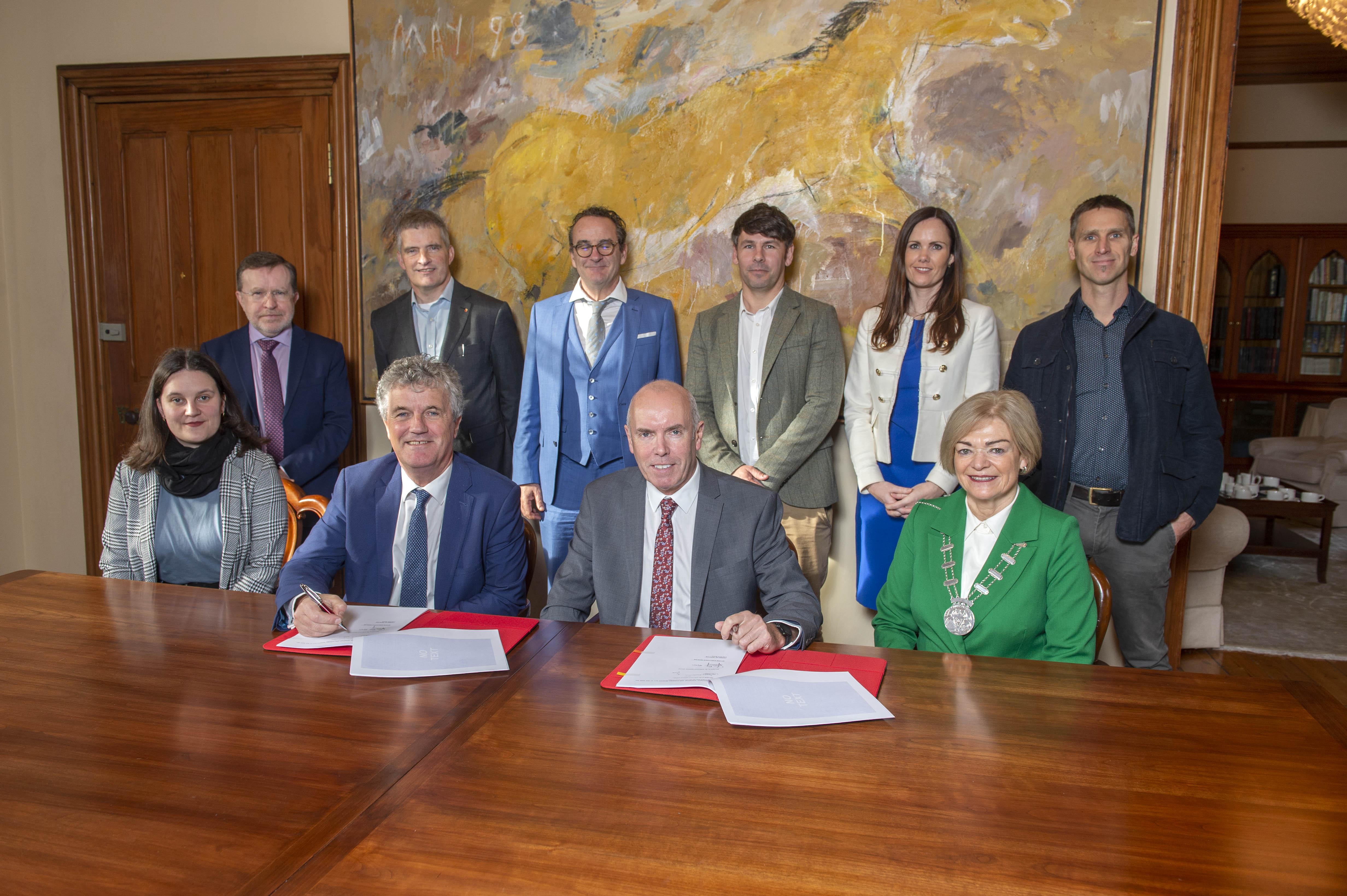 A group of people signing contracts at a table