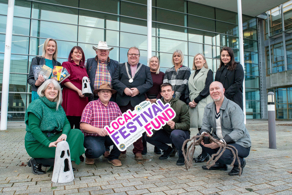 A group of people holding a sign