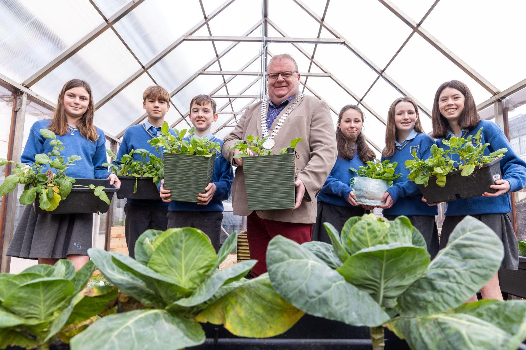 The Mayor of the county of cork with school children, holding flower boxes