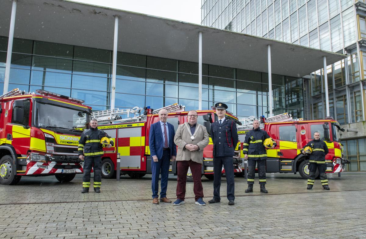 Chief Executive Tim Lucey, Mayor of the County of Cork, Cllr. Danny Collins and Chief Fire Officer Seamus Coughlan along with three members of Cork County Fire Service standing in front of three new fire engines.