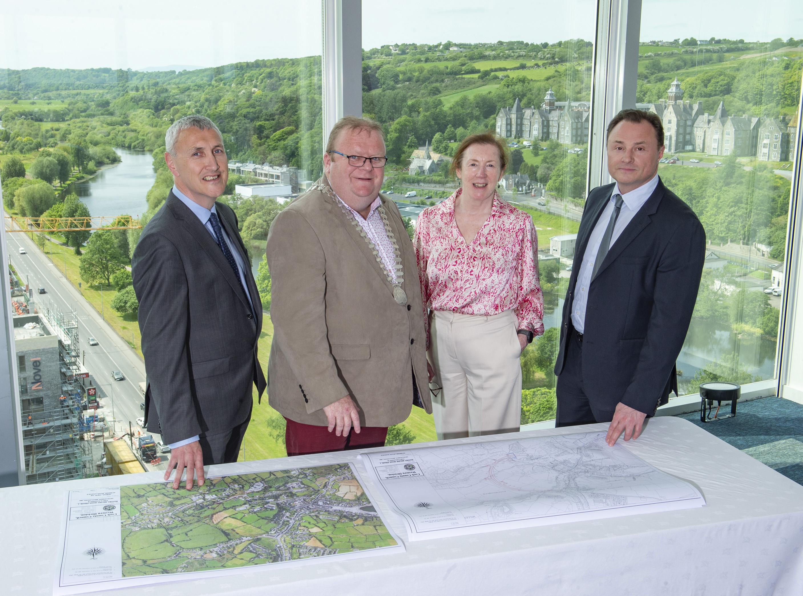 Mayor Collins and 3 others reviewing maps of phase 1 of the Bantry Relief Road.