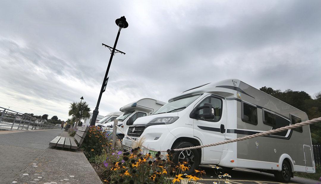 A group of motorhomes parked in a motorhome parking