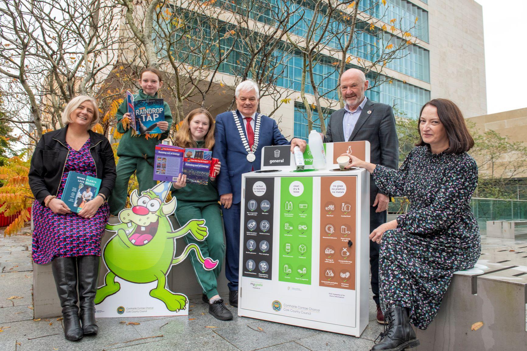 A group of people outside the county hall holding promotional material for make one change 2023