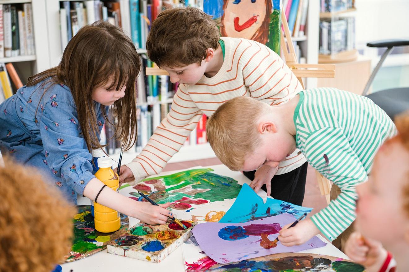 A number of kids creating artwork.