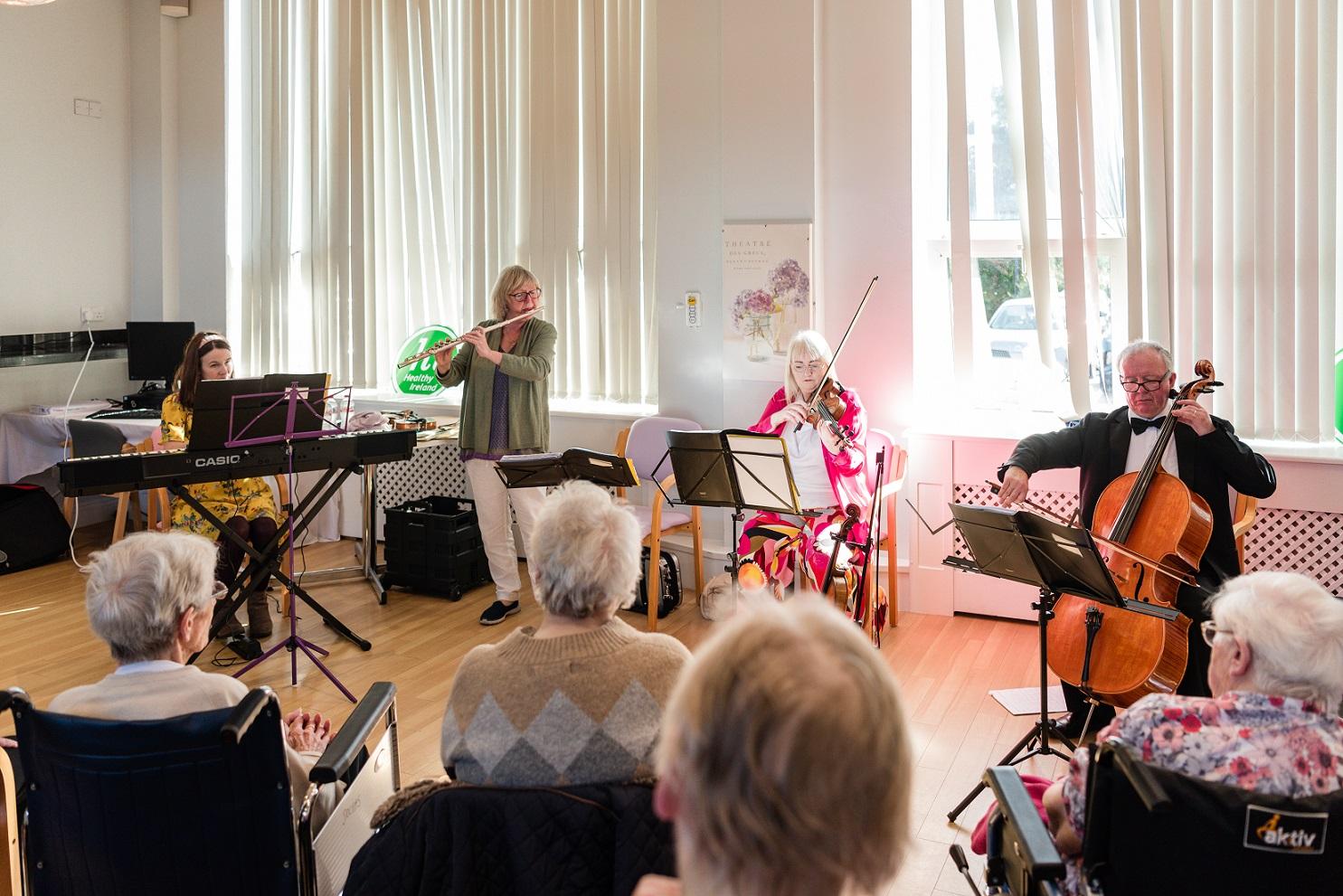 A musical quartet playing in a care home.