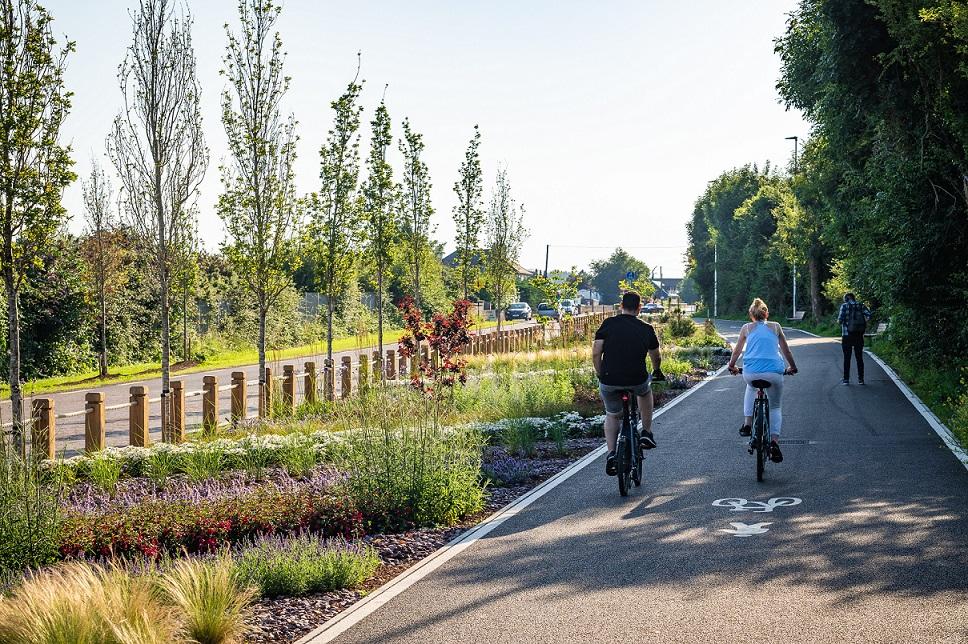 Two people cycling on a designated cycle route.