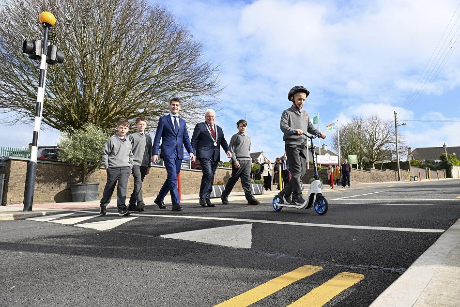 Mayor of the County of Cork, Cllr Frank O’Flynn and Minister of State at the Department of Transport, Jack Chambers TD crossing the road with school pupils.