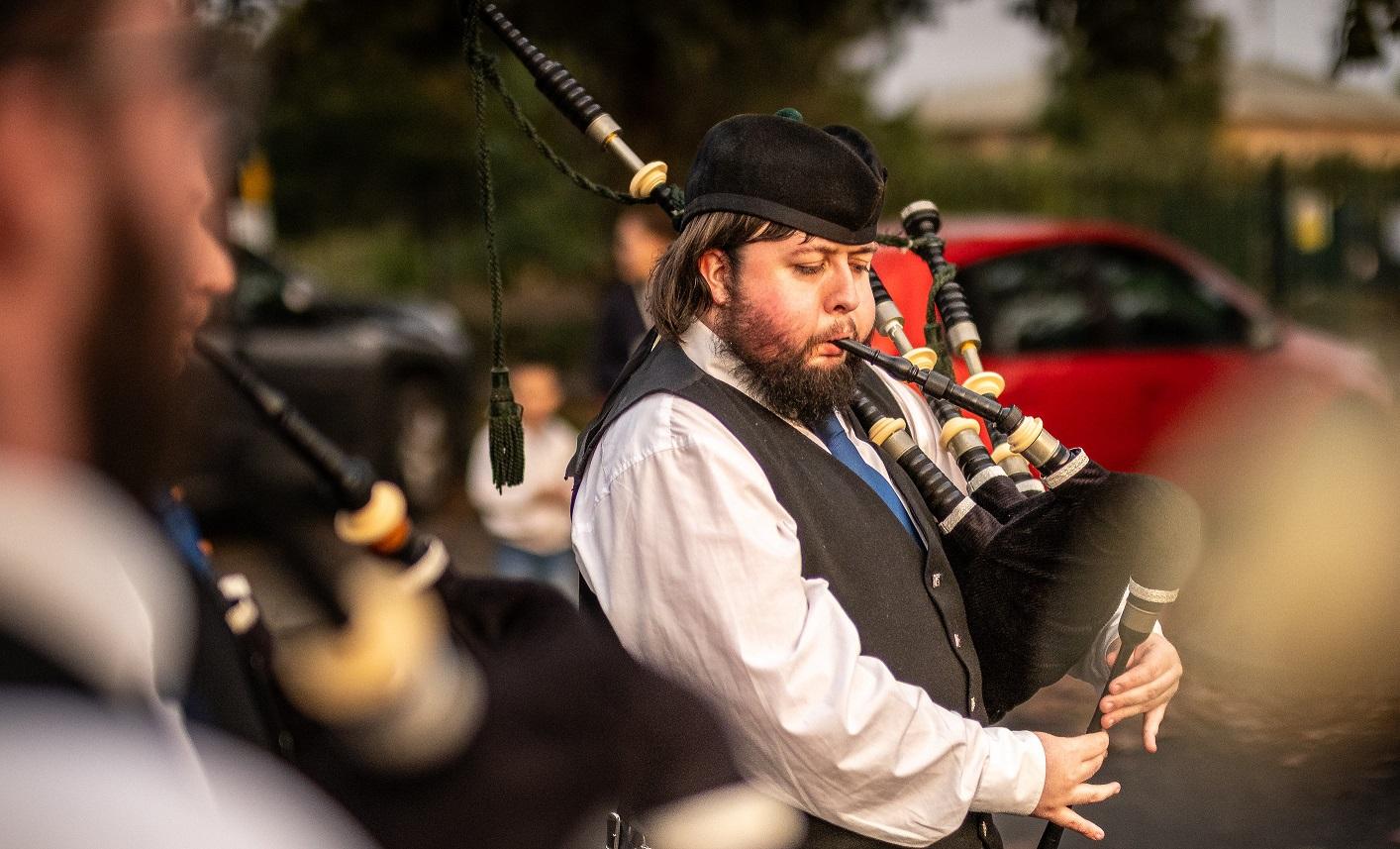 A man playing the bagpipes.