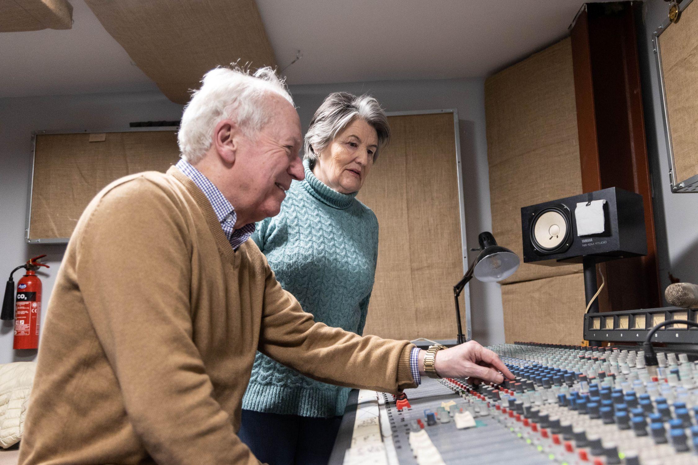 Man and woman using radio switchboard.